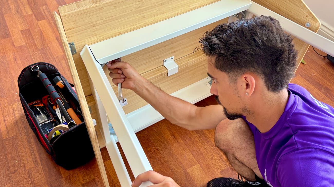 Removal specialist dismantling furniture during a London house move