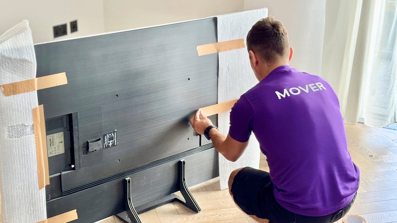 Finest Van removals specialist protecting a TV with premium bubble wrap during a house move