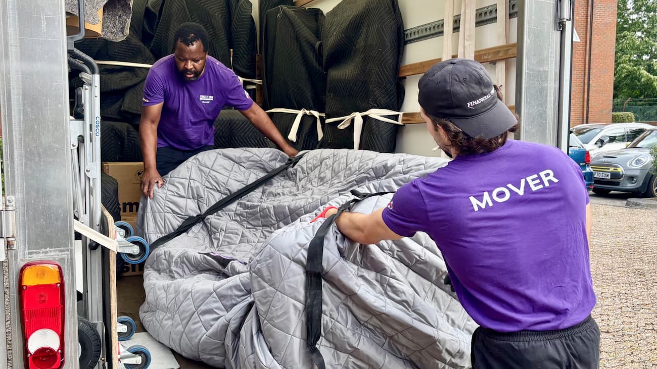 Finest Van removal specialists loading a sofa wrapped in protective covering into a removals van