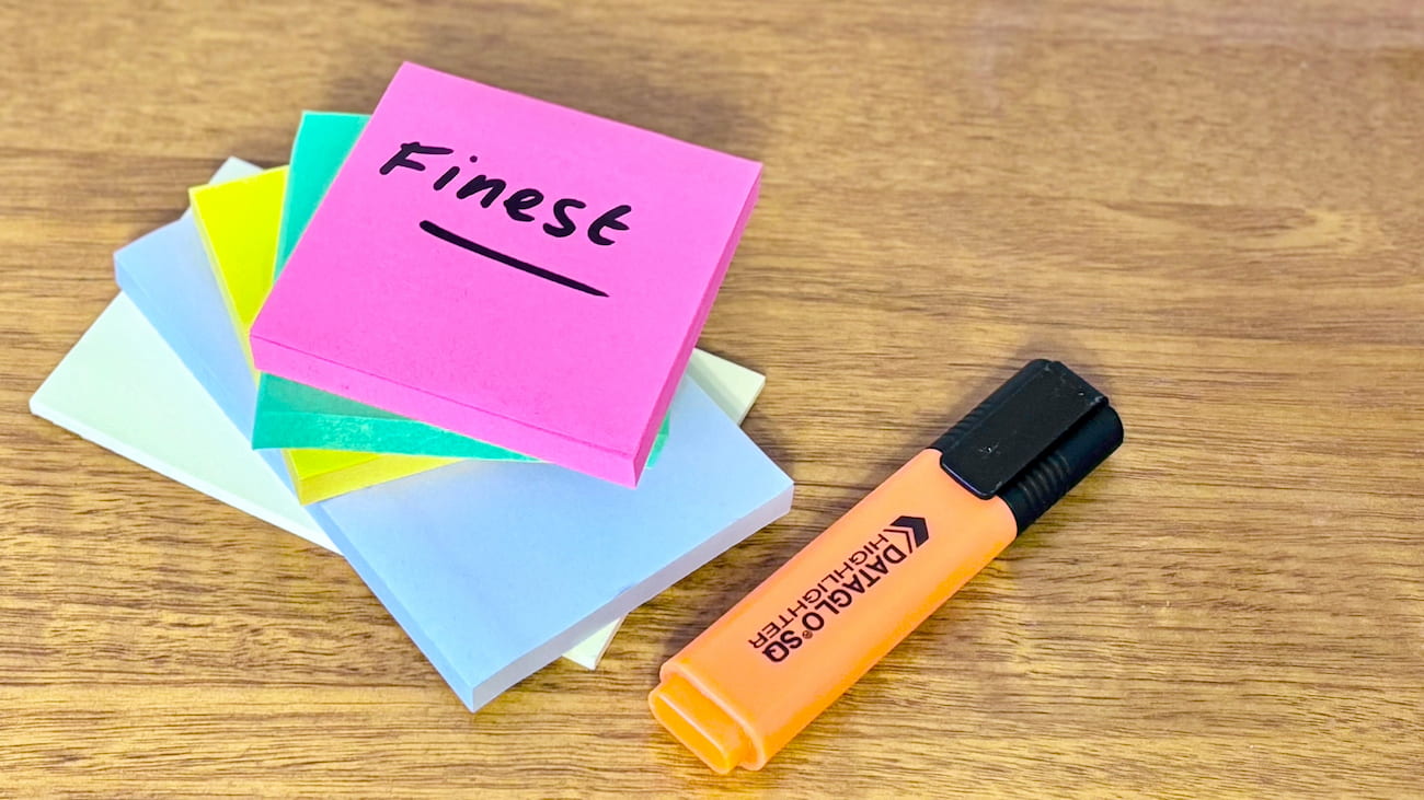 Sticky notes and labels next to a marker pen for office move labelling